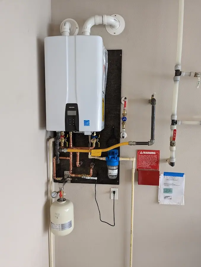 Professional plumber installing copper piping in a Glenolden home